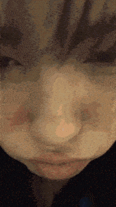 a close up of a person 's face with their eyes closed and their mouth open