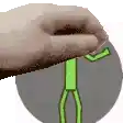a hand is holding a green stick on top of a gray object .