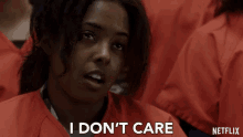 a woman in a prison uniform says i don 't care