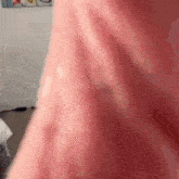 a close up of a person 's pink shirt with a blurred background