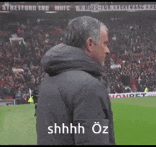 a man on a soccer field with the words shhhh oz written on his face