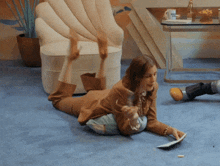 a woman is laying on the floor with her legs up