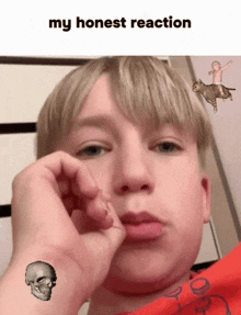 a young boy with a skull tattoo on his wrist and the words my honest reaction