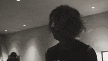 a black and white photo of a man with the letter d on his shirt