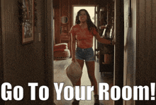 a woman in a red shirt and shorts is standing in a hallway with the words go to your room below her