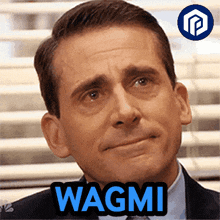 a man in a suit and tie says wagmi in blue