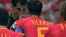 a man wearing a red shirt with the name hierro on it