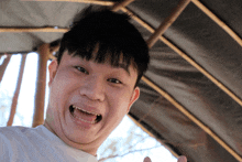 a young man with his mouth open and his tongue out