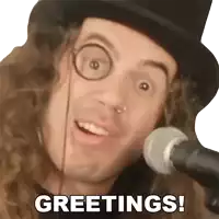 a man with glasses and a top hat says greetings in front of a microphone