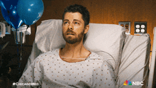 a man in a hospital bed with a nbc logo
