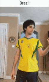 a man in a yellow and green shirt with the word brazil on the bottom