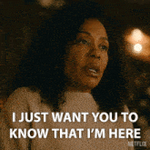 a woman in a sweater says i just want you to know that i 'm here