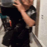 a man in a black shirt is carrying a container on his shoulders