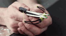 a person is holding a toy crossbow with matches attached to it