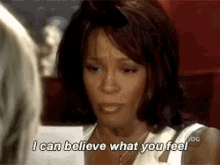 a woman is holding a piece of paper and saying " i can believe what you feel "