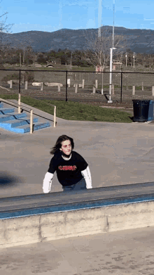a person wearing a t-shirt that says o'neill is riding a skateboard