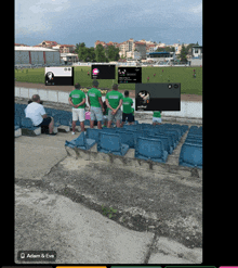 a group of people standing in a stadium wearing green shirts that say " adam & eve "