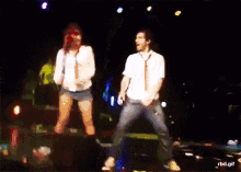 a man and a woman are dancing on a stage with a rbd.gif watermark
