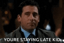 a man in a suit and tie is holding a glass of whiskey and saying `` youre staying late kid '' .