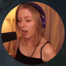a woman wearing headphones is singing into a microphone