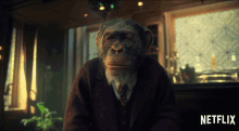 a chimpanzee wearing a suit and tie is sitting in front of a netflix logo