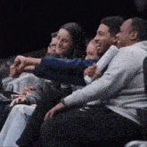 a group of people are sitting in a stadium watching a basketball game