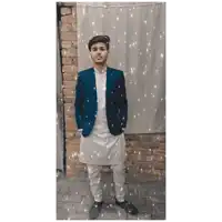 a young man wearing a blue jacket and white pants
