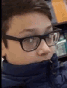 a close up of a person wearing glasses and a scarf