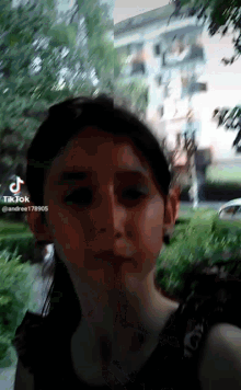 a girl is taking a selfie with a building in the background