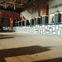 an empty auditorium with a wall of trophies and plaques