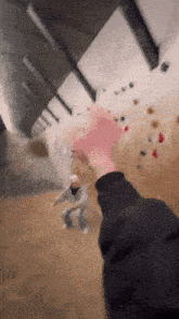 a person is holding a pink object in their hand