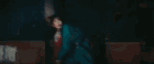 a woman is holding a bat in a dark room .