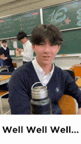 a boy in a classroom with the number 16 written on the blackboard