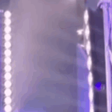 a blurry picture of a building with purple lights .