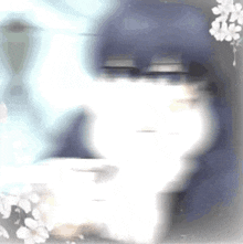 a blurry picture of a person sitting at a table with a cup of coffee .