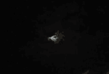 a full moon is shining through the clouds in the night sky