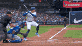 a blue jays player swings at a pitch