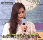 a woman is holding a microphone and saying on some days it 's a great day .