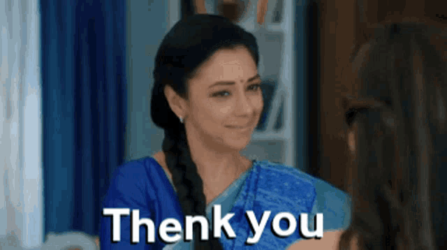 a woman in a blue saree says 