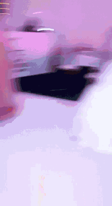 a purple background with a black object in the middle of it