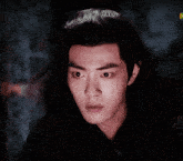 a close up of a young man with a surprised look on his face