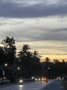 a sunset over a street with a sign that says no parking
