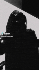 a black and white photo of a person with a tiktok logo