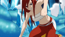 a girl with red hair is kneeling down in front of a waterfall