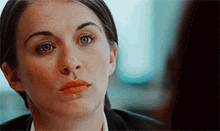 a close up of a woman 's face with a serious look on her face .