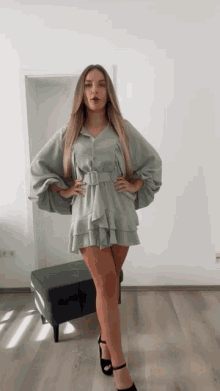 a woman in a ruffled dress is standing in front of a door