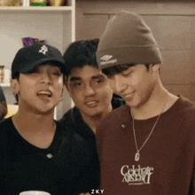 three young men are posing for a picture and one of them is wearing a shirt that says celebrate asian