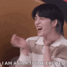 a man is laughing and saying `` i am asian twink excited '' while holding his hands up in the air .
