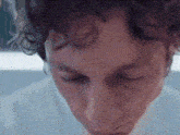 a close up of a man 's face with his eyes closed .