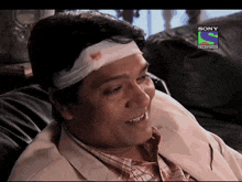 a man with a bandage on his head is on a sony television screen